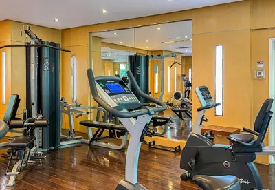 a gym with several treadmills and a treadmill at Park Central, Business Bay - Studio Apartment - Allsopp & Allsopp in Dubai