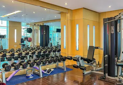 a gym with a lot of equipment in a room at Park Central, Business Bay - Studio Apartment - Allsopp & Allsopp in Dubai