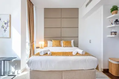 a bedroom with a large bed with two pillows at Park Central, Business Bay - Studio Apartment - Allsopp & Allsopp in Dubai