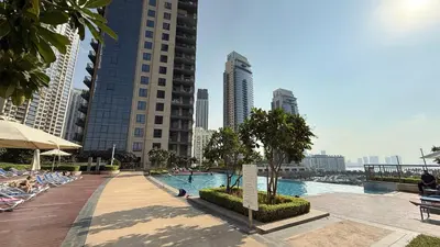 a swimming pool in the middle of a city with buildings at Huge Modern 1BR in Creek Harbour steps to Central Park with a creek view and infinity pool by La Brisa Dubai in Dubai