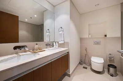 a bathroom with a sink and a toilet at Huge Modern 1BR in Creek Harbour steps to Central Park with a creek view and infinity pool by La Brisa Dubai in Dubai