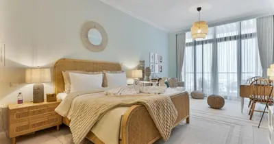 a bedroom with a large bed and a large window at Luxury Studio on Palm Jumeirah Beach Access in Dubai