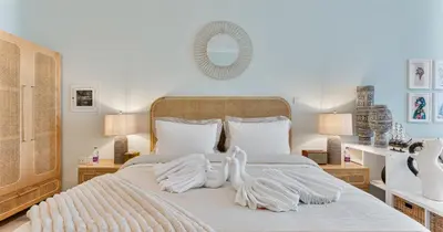 a bedroom with a large bed with two swans on it at Luxury Studio on Palm Jumeirah Beach Access in Dubai