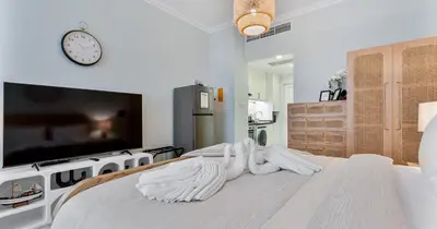 a bedroom with a bed with white towels on it at Luxury Studio on Palm Jumeirah Beach Access in Dubai