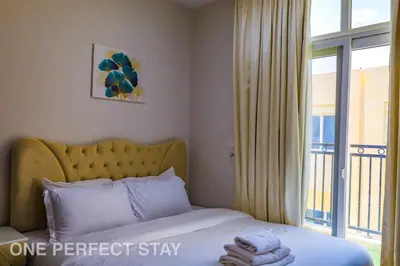 a bedroom with a bed and a large window at Elegant 3BR Villa - Peaceful - Family Friendly in Dubai