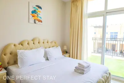 a bedroom with a large bed with a large window at Elegant 3BR Villa - Peaceful - Family Friendly in Dubai