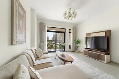 a living room with a couch and a tv at Luxury 1BR in Madinat Jumeirah Living in Dubai