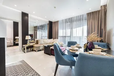 a living room with a couch and a table and chairs at Elegant 1-Bedroom Apartment at Downtown Dubai with Stunning Canal & Skyline Views in Dubai