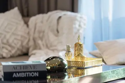 a table with gold items on top of a couch at Elegant 1-Bedroom Apartment at Downtown Dubai with Stunning Canal & Skyline Views in Dubai