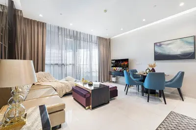 a living room with a couch and a table at Elegant 1-Bedroom Apartment at Downtown Dubai with Stunning Canal & Skyline Views in Dubai