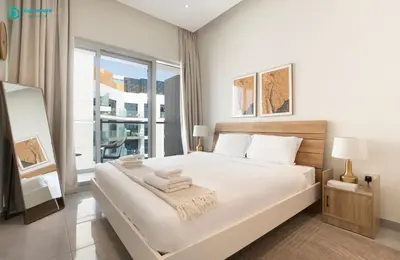 a bedroom with a large white bed with a window at Blue Breeze Modern 2BR Apartment Near Downtown in Dubai