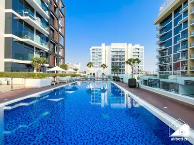a swimming pool in the middle of a building at Bright City ST with Balcony l Pool, Gym & Wi-Fi in Dubai