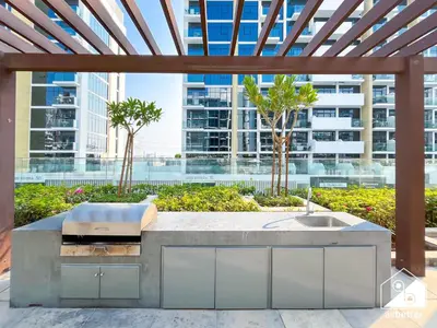 a kitchen with a sink and a view of a city at Bright City ST with Balcony l Pool, Gym & Wi-Fi in Dubai
