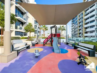 a playground in a building with a slide at Bright City ST with Balcony l Pool, Gym & Wi-Fi in Dubai