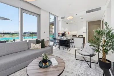 a living room with a couch and a table at Lagoon-Facing 1BR, Minutes from Downtown and Business Bay, Near Dubai Water Canal - District One Phase III Residences 18 by Deluxe Holiday Homes in Dubai