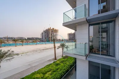 an apartment building with a balcony and a street at Lagoon-Facing 1BR, Minutes from Downtown and Business Bay, Near Dubai Water Canal - District One Phase III Residences 18 by Deluxe Holiday Homes in Dubai