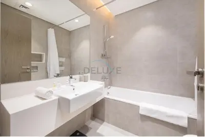 a bathroom with a sink and a bath tub at Lagoon-Facing 1BR, Minutes from Downtown and Business Bay, Near Dubai Water Canal - District One Phase III Residences 18 by Deluxe Holiday Homes in Dubai