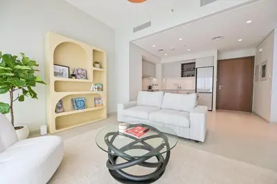 a living room with a white couch and a table at Vida Residences - Luxury & Serenity - Creek Beach in Dubai