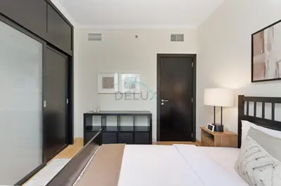 a bedroom with a bed and a desk at Prime 2BR with Mesmerizing Canal Views, Stone Throw from Marina Mall and Metro, Minutes Walk to JBR Beach, Al Majara 1, Dubai Marina by Deluxe Holiday Homes in Dubai
