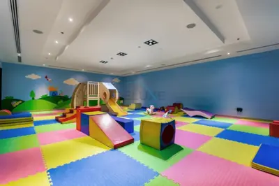 a childrens play room with colorful floors and a slide at Prime 2BR with Mesmerizing Canal Views, Stone Throw from Marina Mall and Metro, Minutes Walk to JBR Beach, Al Majara 1, Dubai Marina by Deluxe Holiday Homes in Dubai