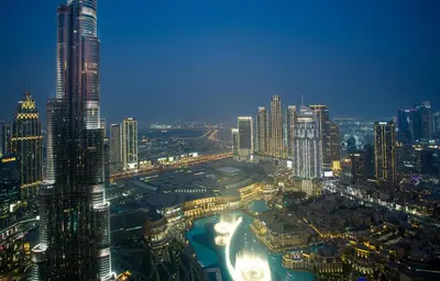 a view of a city at night with lights at Skyline Splendor 2bedroom with Burj Khalifa View in Dubai