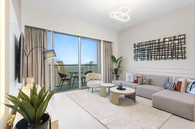 a living room with a couch and a table at Skyline Splendor 2bedroom with Burj Khalifa View in Dubai