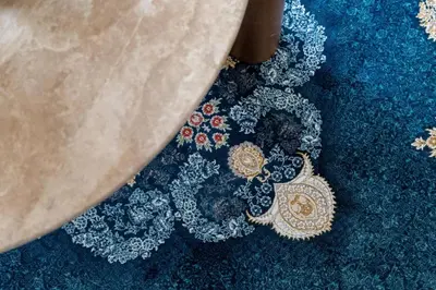 a close up of a necklace on a blue carpet at GuestReady - 2BR l High-Rise Elegance in Dubai