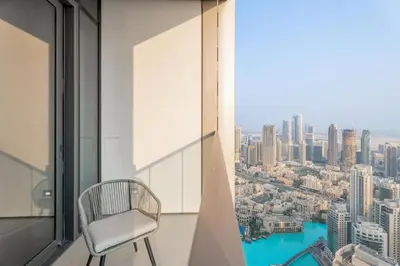 a chair in a room with a view of a city at GuestReady - 2BR l High-Rise Elegance in Dubai