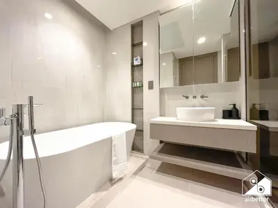 a white bathroom with a tub and a sink at Luxury Canal-View Retreat l 3BR with Balcony & Pool in Dubai