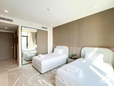 a hotel room with two beds and a mirror at Luxury Canal-View Retreat l 3BR with Balcony & Pool in Dubai