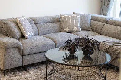a living room with a couch and a glass table at Beachfront 1BR with Private Beach Access in Dubai