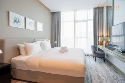 a hotel room with a large bed and a desk at Modern Canal Studio near Downtown Dubai in Dubai