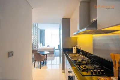 a kitchen with a sink and a stove at Modern Canal Studio near Downtown Dubai in Dubai