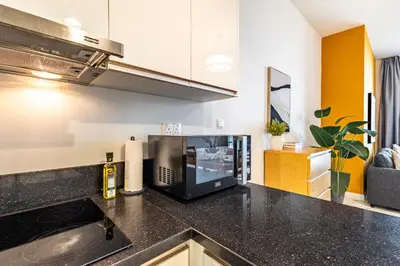 a kitchen with a sink and a microwave at Best Business Bay Location - Direct Views of Canal and Al Khail Racecourse - 1 min from Al Habtoor Palace in Dubai