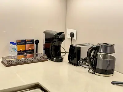 a kitchen counter with a coffee maker and a toaster at JBR Beach Access Luxury1BR Marina View High Floor in Dubai