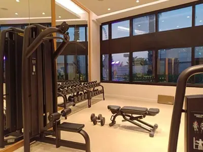 a gym with rows of exercise equipment in a building at JBR Beach Access Luxury1BR Marina View High Floor in Dubai