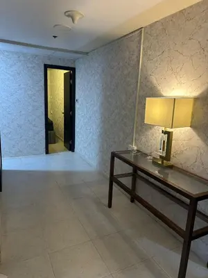 a living room with a table and a lamp at Private Room Steps from Marina Beach Dubai in Dubai