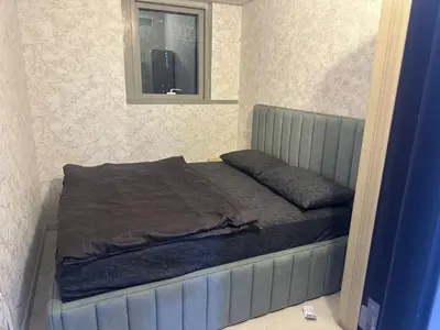 a bed with a blue bed frame in a bedroom at Private Room Steps from Marina Beach Dubai in Dubai