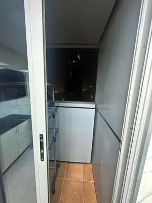 an open door to a room with a view of a city at Private Room Steps from Marina Beach Dubai in Dubai