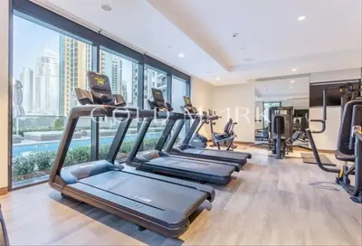 a gym with treadmills and exercise equipment in a building at Stunning One bed Dubai mall downtown in Dubai