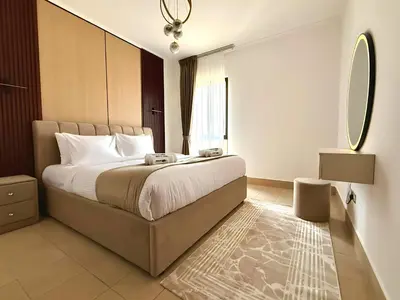a bedroom with a large bed and a mirror at Downtown Burj Khalifa View One Bedroom Apartment in Dubai
