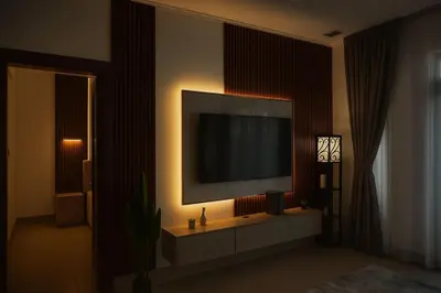 a living room with a flat screen tv on a wall at Downtown Burj Khalifa View One Bedroom Apartment in Dubai