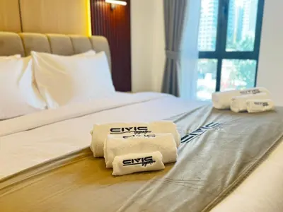 a hotel room with three towels on a bed at Downtown Burj Khalifa View One Bedroom Apartment in Dubai