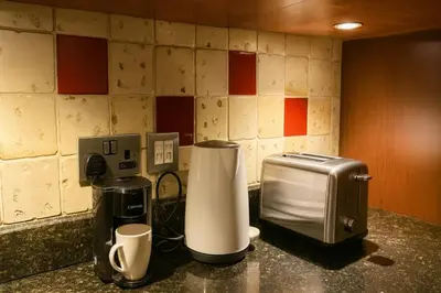 a counter with a toaster and a toaster and a coffee maker at Downtown Burj Khalifa View One Bedroom Apartment in Dubai