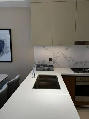 a kitchen with a sink and a counter top at 2 Bedroom Apartment in Address Opera Residences in Dubai
