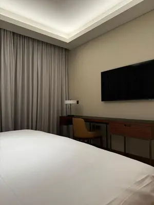 a bedroom with a bed and a desk and a television at 2 Bedroom Apartment in Address Opera Residences in Dubai