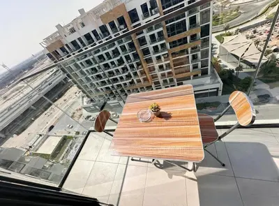 a wooden bench sitting on top of a building at Kanisha Homes Azizi Riviera 48 by Vacay Xeal in Dubai