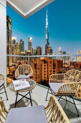 a balcony with chairs and a view of the city at Premium 3BR apartment with Burj Khalifa view, Downtown Dubai in Dubai