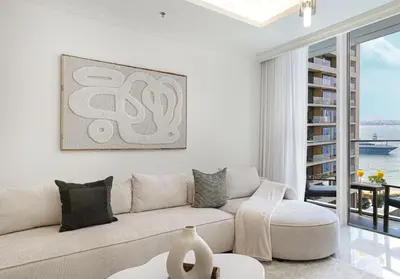a white living room with a couch and a table at Palace Beach Residences By Luxe Living - Palm & Marina View in Dubai
