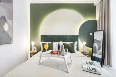 a bedroom with a bed with a table with fruit on it at Palace Beach Residences By Luxe Living - Palm & Marina View in Dubai
